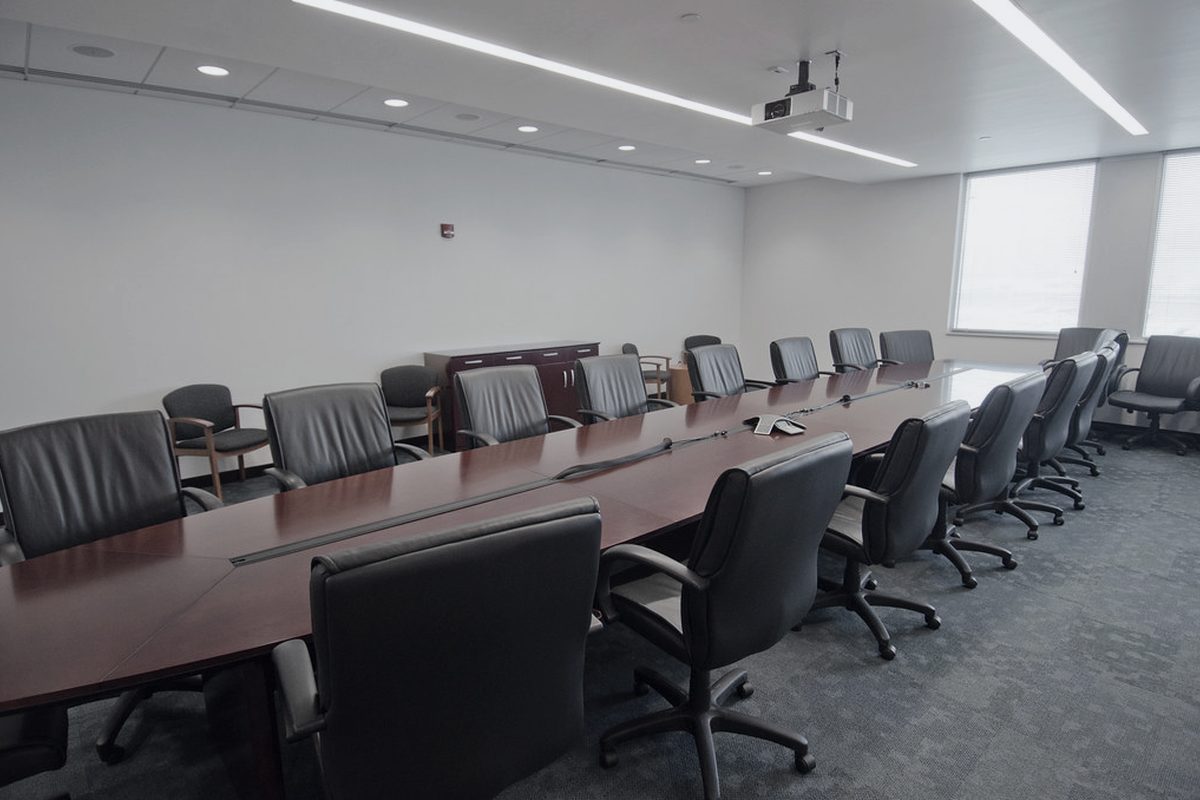 A long conference room arranged for a multi party deposition